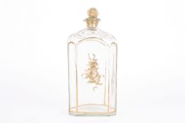A large early 19th century gilt decorated glass decanter and stopper of rectangular form with canted