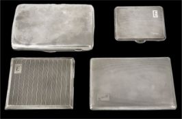 Three hallmarked silver cigarette cases with hinged opening and each with engine turned decoration