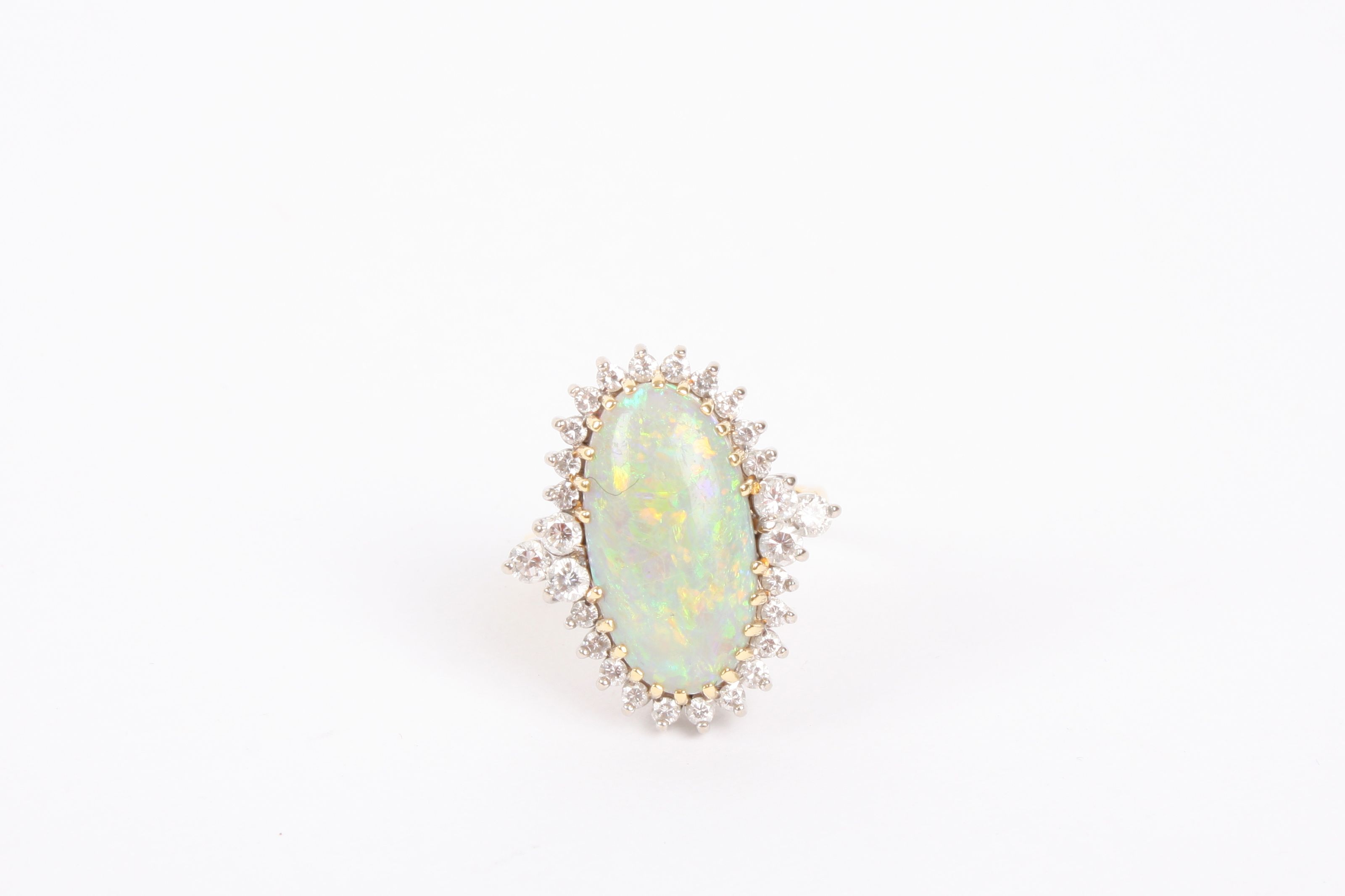 A large contemporary oval opal and diamond set fancy ring the opal measuring approx. 2 cm top to