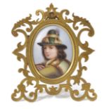 A Victorian gilt framed painted porcelain oval portrait miniature of a young boy in traditional