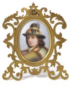 A Victorian gilt framed painted porcelain oval portrait miniature of a young boy in traditional