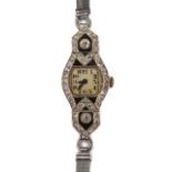 A 1920s platinum and diamond cocktail watch of lozenge shaped form, set with two diamond of