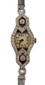 A 1920s platinum and diamond cocktail watch of lozenge shaped form, set with two diamond of