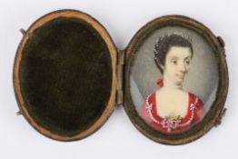 A 19th century miniature portrait of a young lady painted on ivory, the lady wearing a red dress