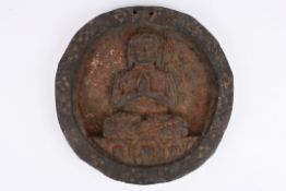 An unusual antique carved wooden plaque carved with a seated Buddha. 22.5 cm diameter.Condition: