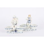 A pair of 20th century Meissen porcelain blue and white figural table salts each mounted with a