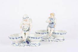 A pair of 20th century Meissen porcelain blue and white figural table salts each mounted with a