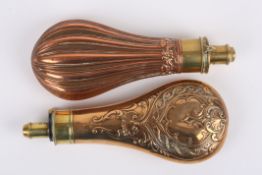 Two 19th century power flasks one with fluted body, the other with embossed scrolls, both with brass