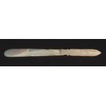 An early 20th century carved mother of pearl paper knife with fluted handle and acanthus collar.