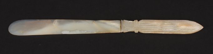 An early 20th century carved mother of pearl paper knife with fluted handle and acanthus collar.