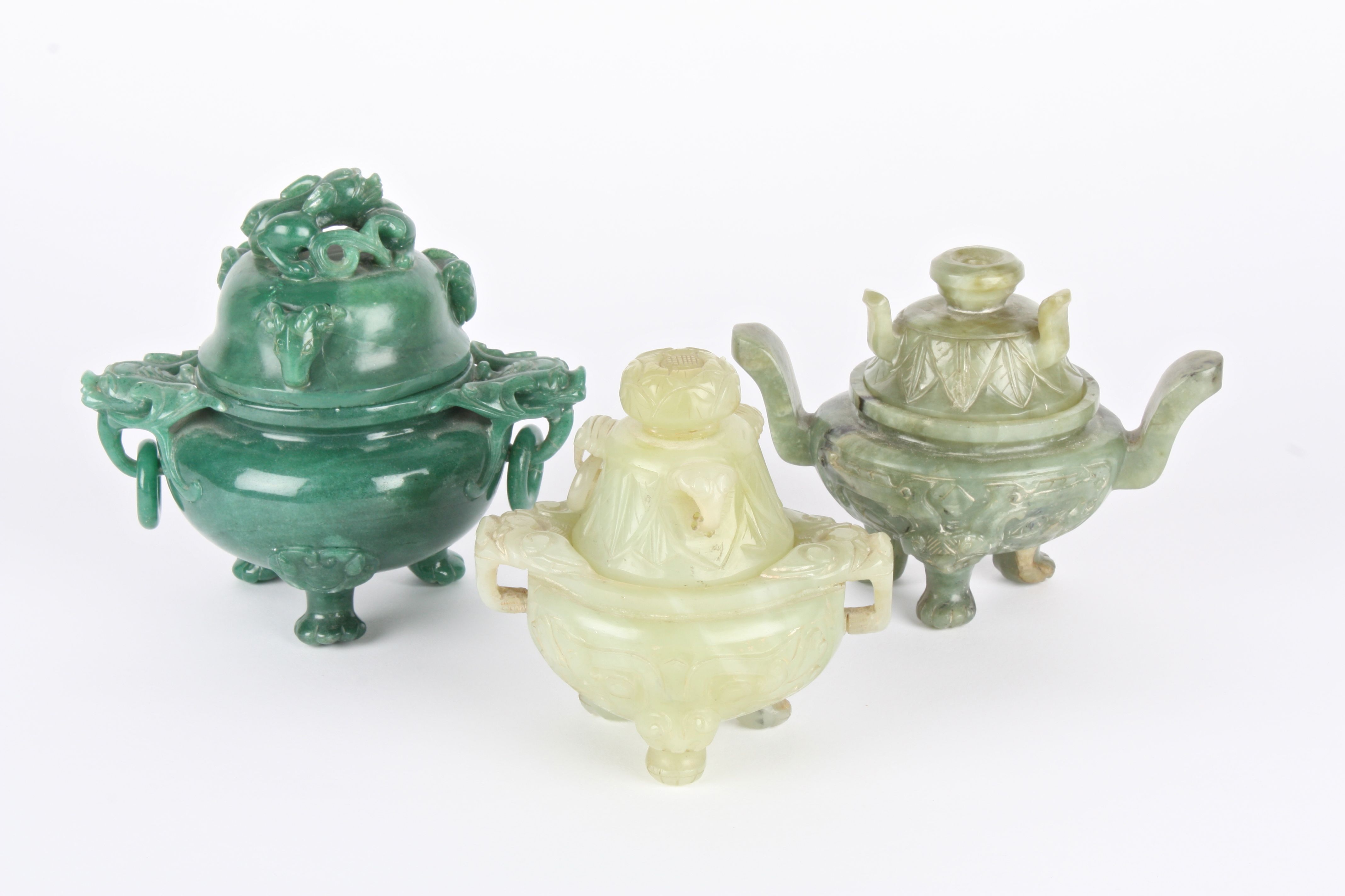 A group of three modern Chinese jade and hardstone koros and covers each with carved decoration, two