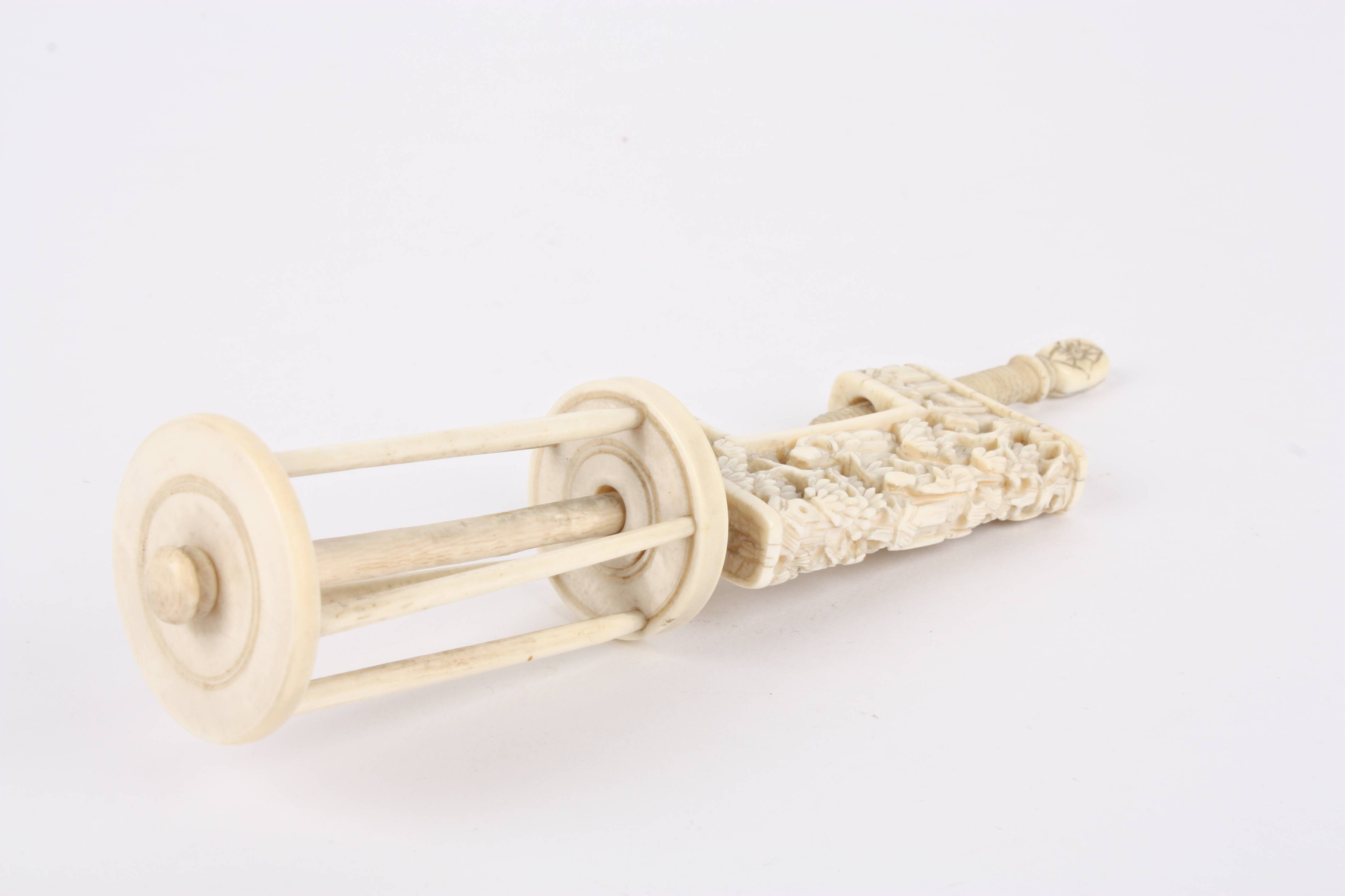 A late 19th century Chinese canton ivory bobbin clamp carved with figures, buildings and foliage. - Image 3 of 3