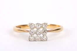 An Art Deco nine stone diamond set ring, the stones mounted in an open lattice design, square