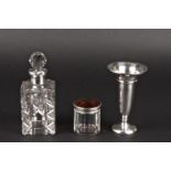 A silver mounted and cut glass perfume bottle together with a silver trumpet shaped bud vase, and