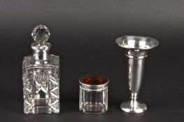 A silver mounted and cut glass perfume bottle together with a silver trumpet shaped bud vase, and