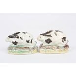 A small pair of Staffordshire pottery seated models of rabbits c. 1830, supported on painted