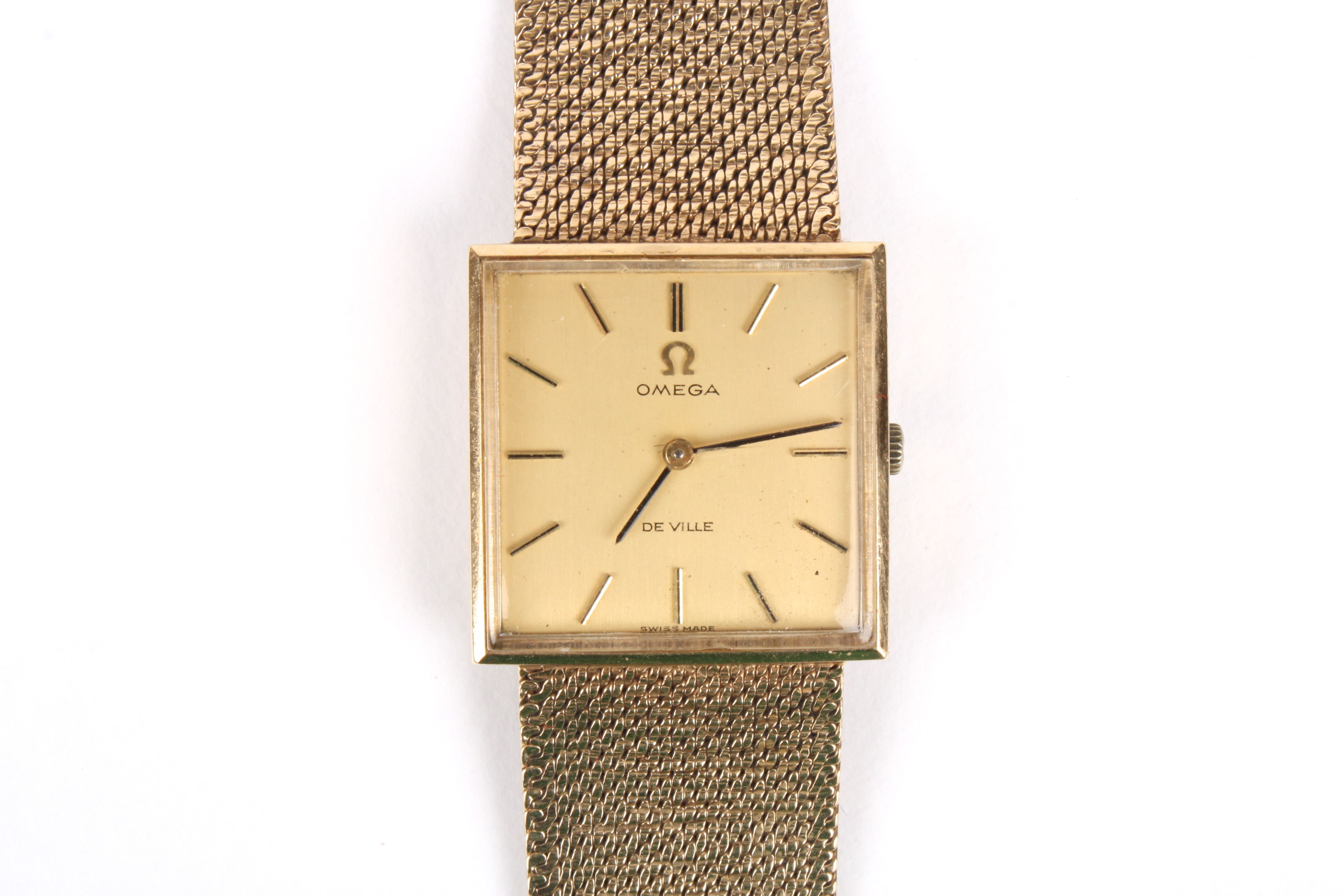 An Omega de Ville 9ct gold mechanical wrist watch with square gilded dial and baton numerals, the 17