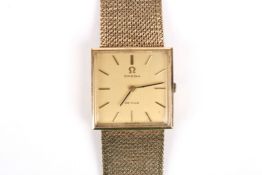 An Omega de Ville 9ct gold mechanical wrist watch with square gilded dial and baton numerals, the 17