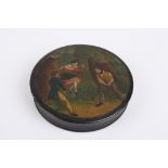 A 19th century black lacquer snuff box of circular form, decorated with a scene of a woman on a