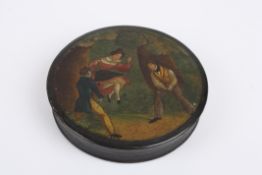 A 19th century black lacquer snuff box of circular form, decorated with a scene of a woman on a