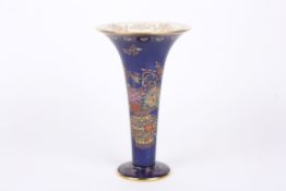 A Carlton Ware Bleu Royale trumpet vase decorated with a vase of enamel flowers with rich gilt