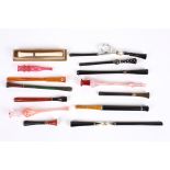A collection of eleven assorted 1920s cigarette holders of various shapes and designs, some