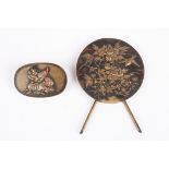 A small Japanese circular bronze plaque decorated in relief with birds and flowers, with easel
