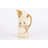 A Royal Worcester ivory ground jug, decorated with flowers and mask mount, puce mark and numbered