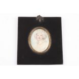A 19th century oval portrait miniature of a young woman painted on ivory, her hair in ringlets and