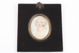 A 19th century oval portrait miniature of a young woman painted on ivory, her hair in ringlets and