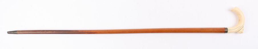 A Victorian carved ivory and malacca walking stick the handle carved with a male mask, with tapering