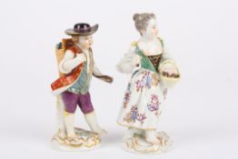 Two 20th century Meissen porcelain figures of a boy and girl the boy with a basket of grapes on