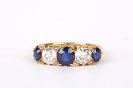 An attractive antique, sapphire and diamond set five stone half hoop ring with central sapphire