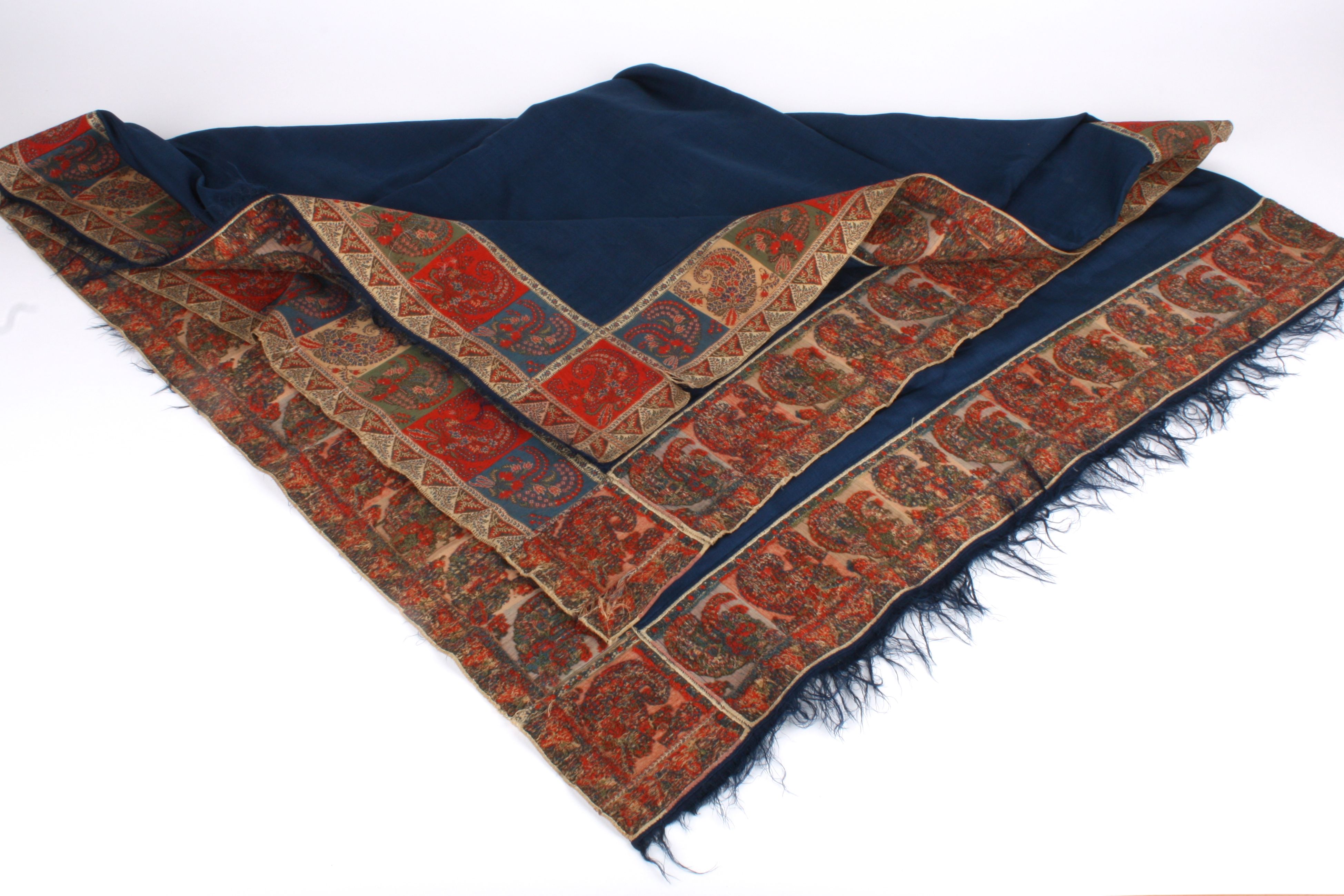 An Early Victorian fine woollen paisley shawl of blue wool with jacquard woven edge trims matching