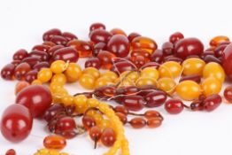 A large Chinese amber type necklace of graduated opaque ovoid beads another graduated necklace of