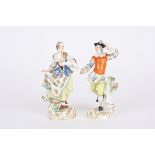 A pair of 20th century Meissen porcelain figures of a dancing man and woman both wearing colourful