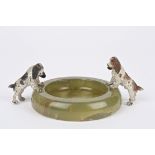 A cold painted bronze and onyx ashtray mounted with two well modelled spaniels standing on the rim