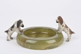 A cold painted bronze and onyx ashtray mounted with two well modelled spaniels standing on the rim