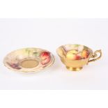 A Royal Worcester painted cup and saucer by William Ricketts painted with apples, blackberries,