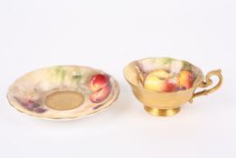 A Royal Worcester painted cup and saucer by William Ricketts painted with apples, blackberries,