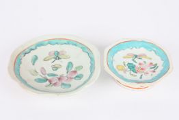 Two 19th century Chinese plates, decorated with enamel flowers and a butterfly, one with larger