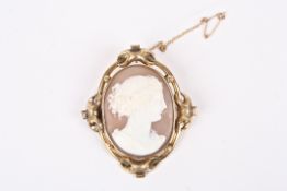 A Victorian carved shell cameo oval brooch with a portrait of a classical lady, in a yellow metal