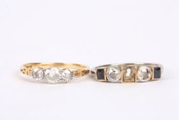 An antique three stone diamond set ring the centre stone approx. 0.25ct, flanked by two smaller