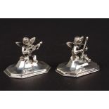 A pair of Stirling silver menu holders formed as cherubs playing musical instruments. Condition: