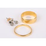 A wide hallmarked 22ct gold wedding band sold together with a narrow hallmarked 22ct gold wedding