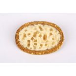 A 19th Century Chinese Canton carved ivory brooch the three dimensional carving detailing an