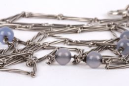 A 1920s silver and moonstone long necklace set with six moonstone coloured beads on a wire twist