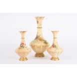 A garniture of three Royal Worcester blush ivory vases comprising a large and a small pair of vases,