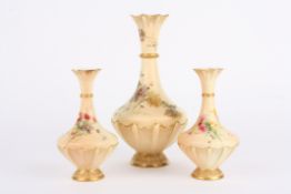 A garniture of three Royal Worcester blush ivory vases comprising a large and a small pair of vases,