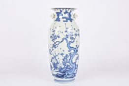 A large 19th century Japanese blue and white vase decorated with a prunus tree and trailing